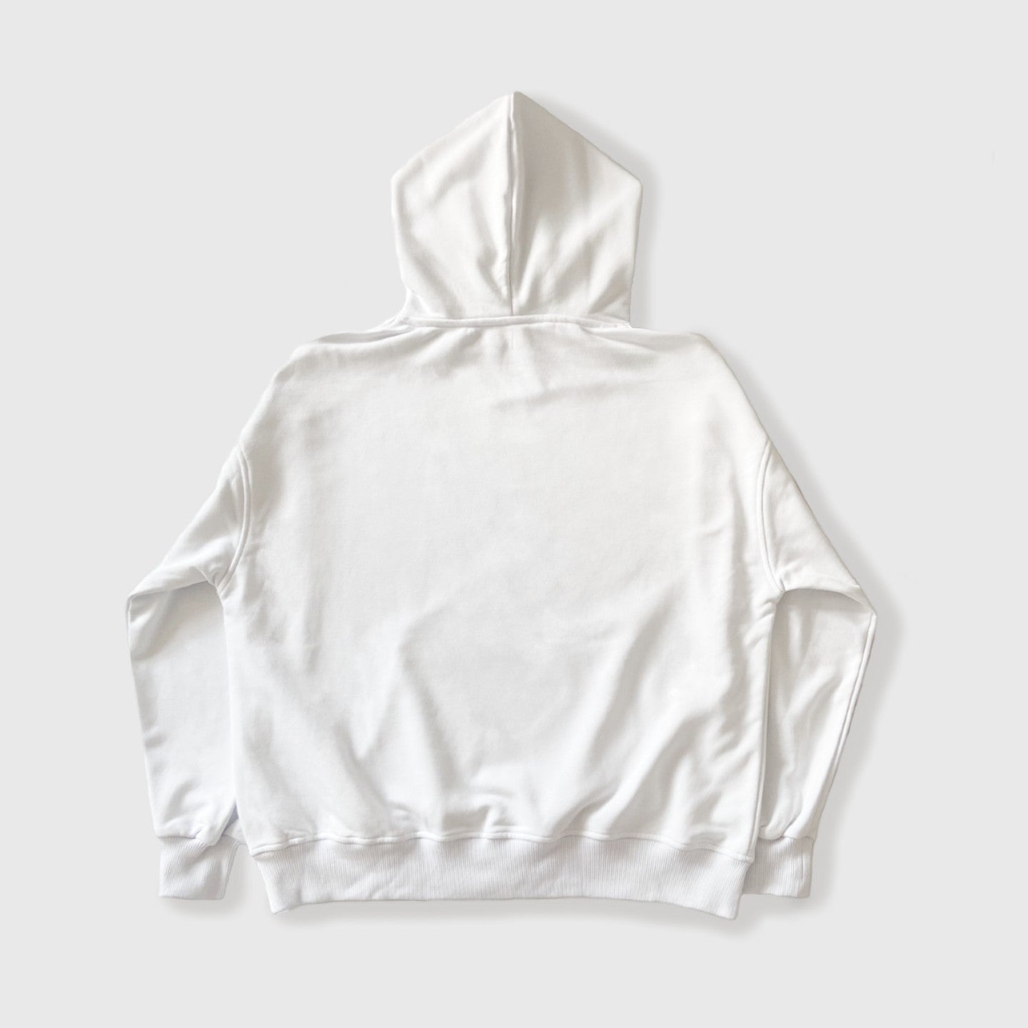 Back side of oversized white 100% cotton hoodie, against white background.