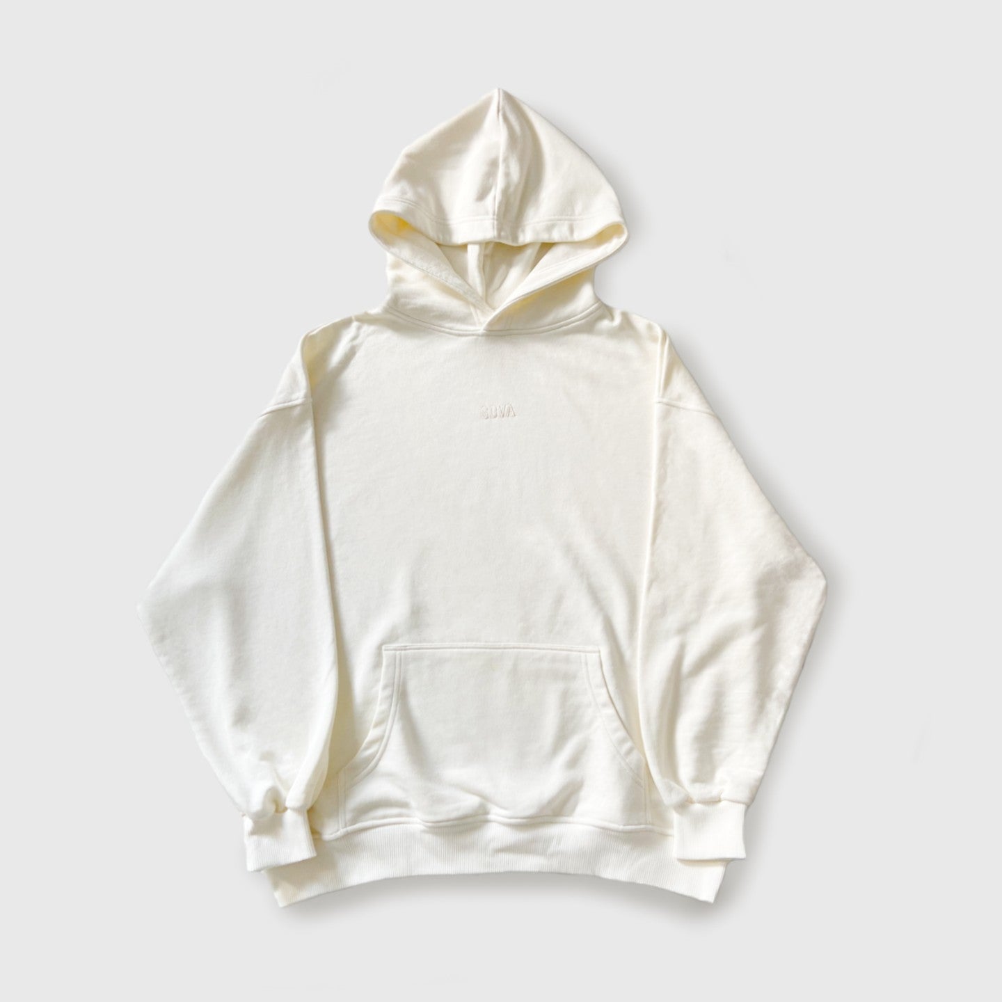 White/cream oversized cotton hoodie against white background.