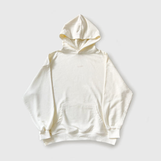White/cream oversized cotton hoodie against white background.